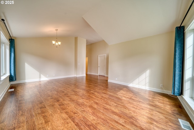 2639 Sykes Rd, Saint Helens, OR 97051 - spare room with light wood-type flooring, a chandelier, baseboards, a barn door, and vaulted ceiling