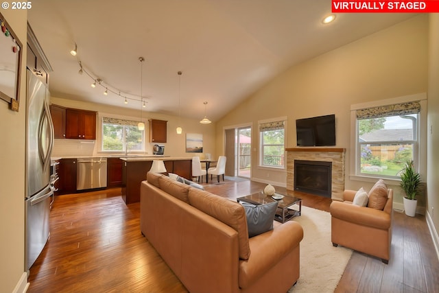 2639 Sykes Rd, Saint Helens, OR 97051 - living room featuring hardwood / wood-style floors, a tile fireplace, lofted ceiling, baseboards, and recessed lighting