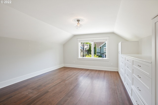 bonus room featuring dark hardwood / wood-style floors and vaulted ceiling