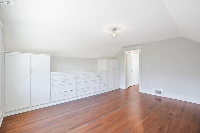 bonus room featuring dark hardwood / wood-style flooring and vaulted ceiling