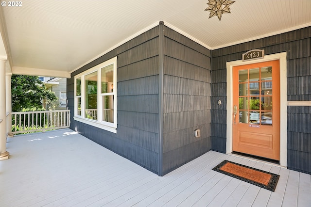 view of exterior entry with covered porch