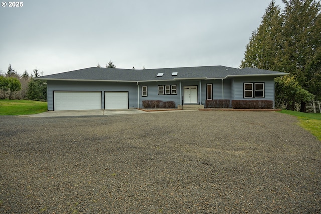 ranch-style house featuring concrete driveway and a garage