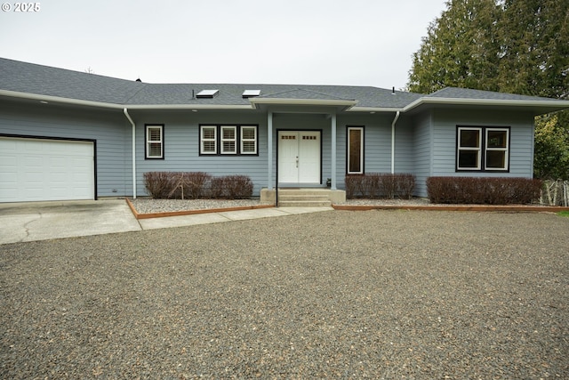 view of front facade featuring an attached garage, concrete driveway, and roof with shingles