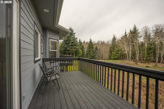 wooden terrace with a lawn