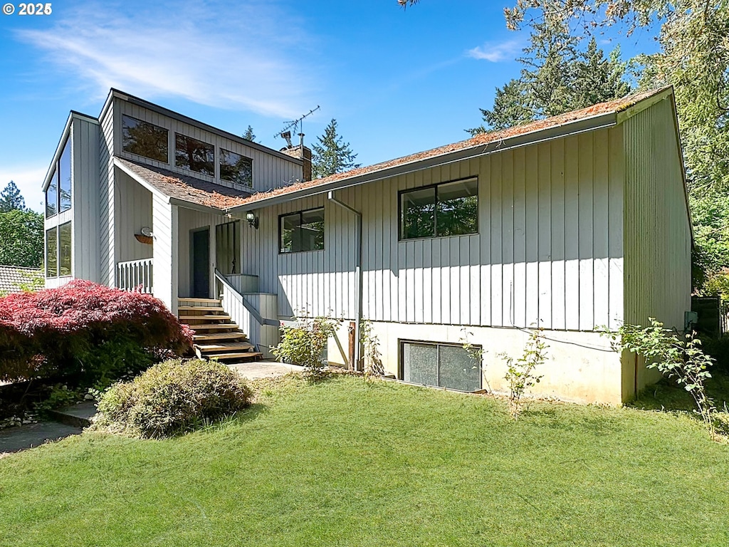 back of property featuring a yard