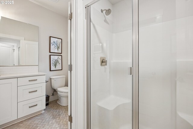 12545 SW Palermo St, Wilsonville, OR 97070 - full bathroom featuring a shower stall, toilet, vanity, and brick patterned floors