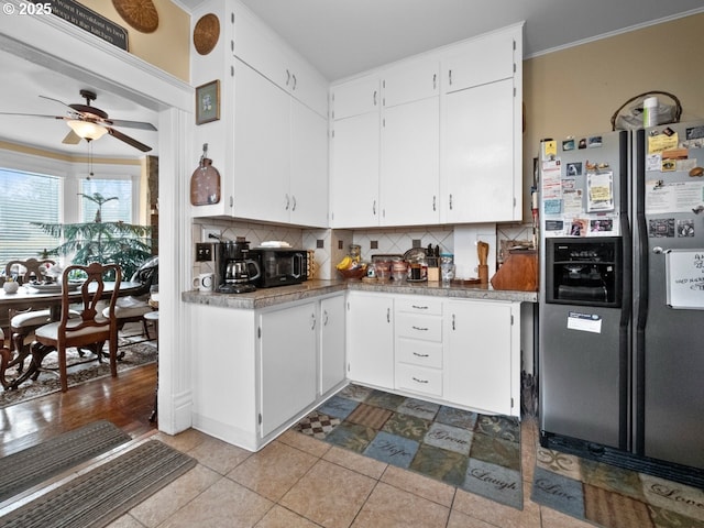 kitchen with tasteful backsplash, white cabinetry, ceiling fan, and stainless steel fridge with ice dispenser