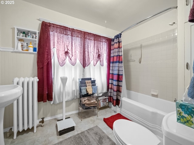 full bathroom with a wainscoted wall, radiator heating unit, tile patterned flooring, shower / bath combination with curtain, and toilet