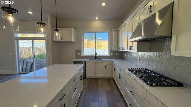 11684 SW 178th Dr, Beaverton, OR 97007 - kitchen with under cabinet range hood, a chandelier, double oven, a kitchen island, and white cabinets