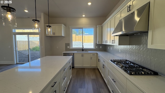 kitchen with tasteful backsplash, stainless steel appliances, under cabinet range hood, white cabinets, and dark wood-style flooring