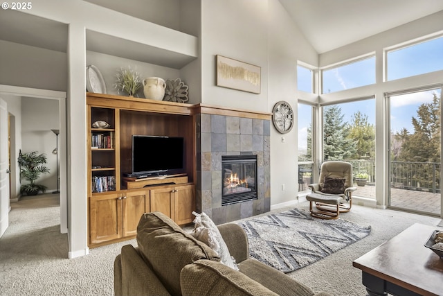 carpeted living room featuring high vaulted ceiling and a fireplace