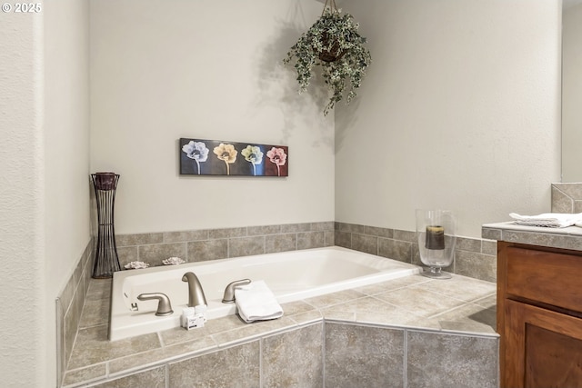 bathroom with vanity and tiled bath