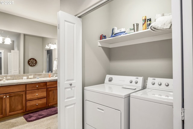 laundry area with sink, light colored carpet, and washing machine and clothes dryer