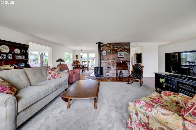 carpeted living area featuring a wood stove