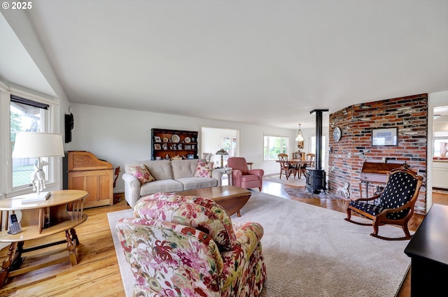 living area with a wood stove and light wood-style flooring