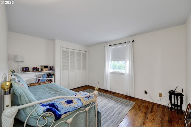 bedroom featuring a closet, wood finished floors, and visible vents