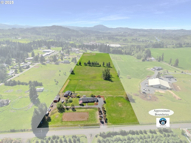 drone / aerial view with a mountain view and a rural view
