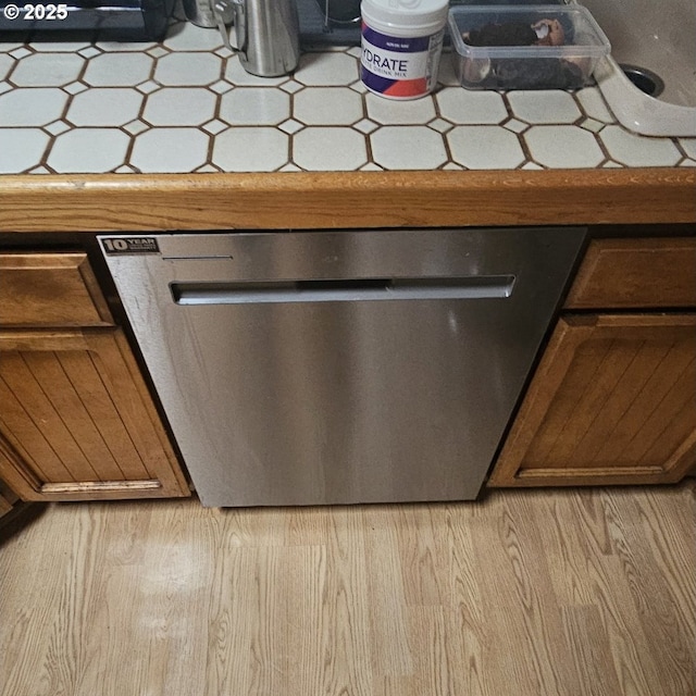 room details featuring light hardwood / wood-style flooring and dishwasher