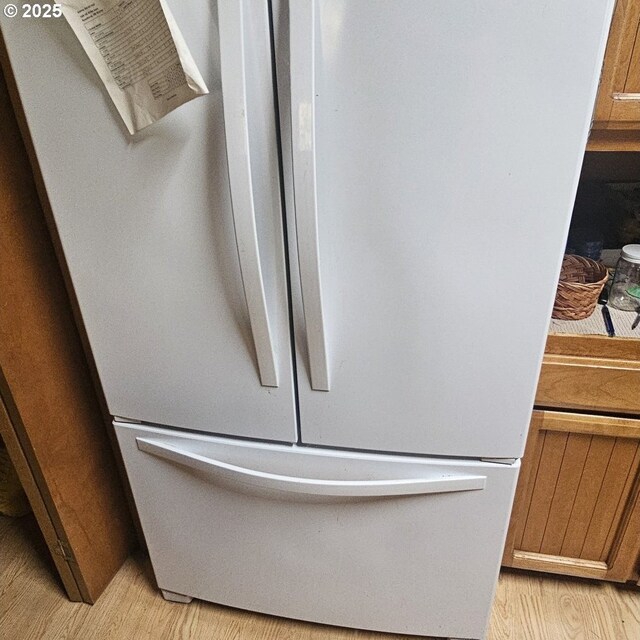 interior details featuring light hardwood / wood-style floors and white fridge