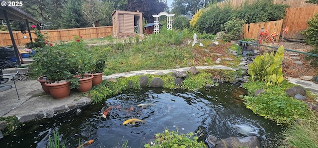 view of yard featuring a garden pond