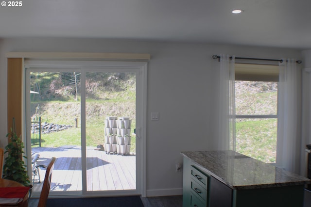 doorway featuring wood finished floors, baseboards, and recessed lighting