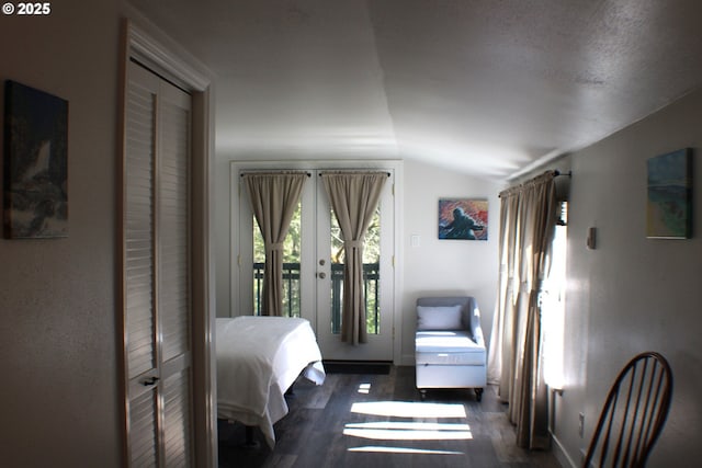 bedroom featuring vaulted ceiling, access to outside, and wood finished floors