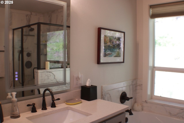 full bath featuring a garden tub, vanity, and a stall shower