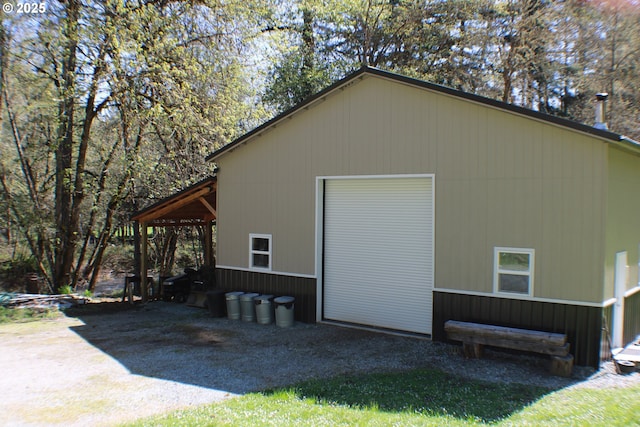 view of side of home featuring an outbuilding and a garage