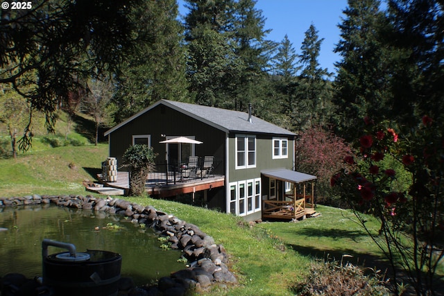 back of house featuring a yard and a deck