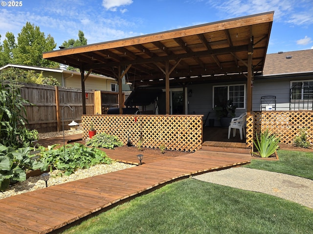 wooden terrace with a yard