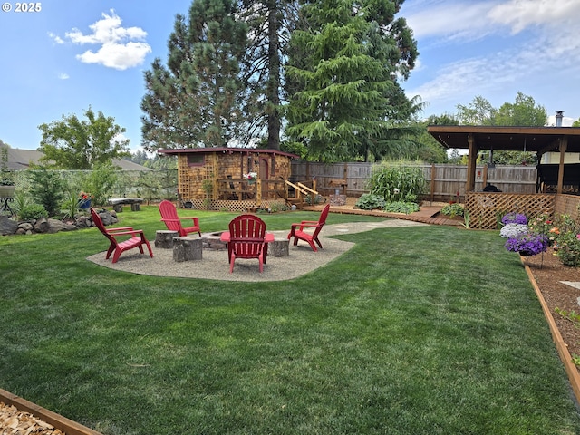 view of yard featuring a fire pit and a wooden deck