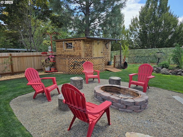 view of patio / terrace with an outbuilding and a fire pit