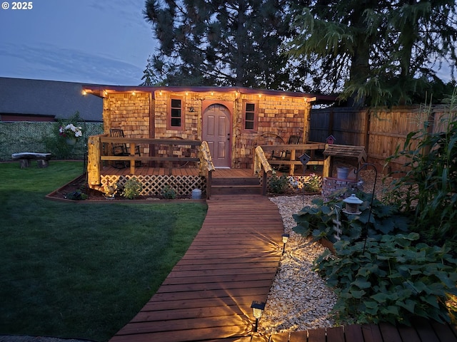 exterior space featuring a front lawn and a deck