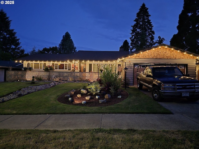 single story home featuring a yard and a garage