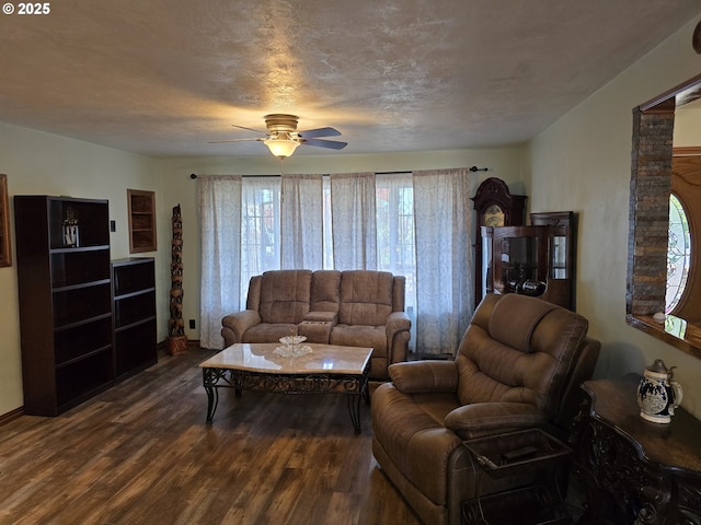 living room featuring a textured ceiling, dark hardwood / wood-style flooring, and ceiling fan