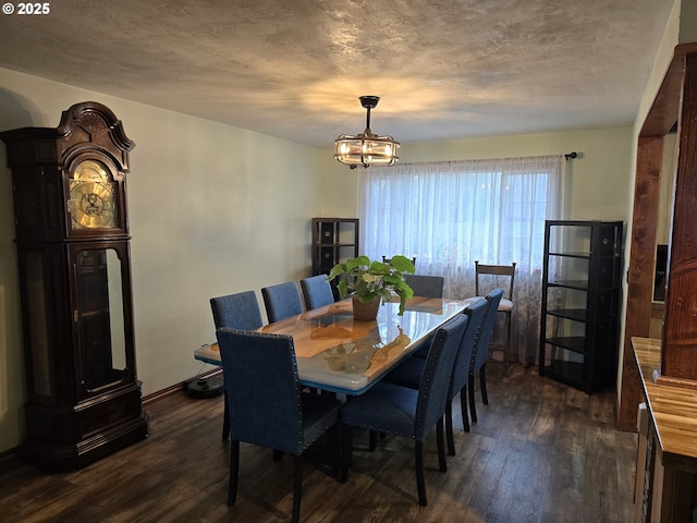 dining area featuring a textured ceiling, dark hardwood / wood-style flooring, and a notable chandelier