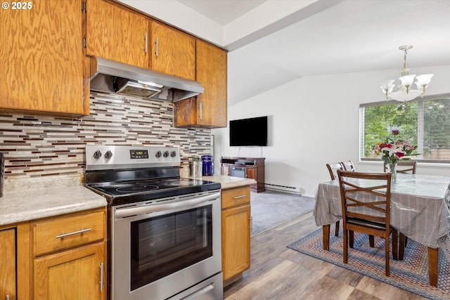 18366 SW Jann Dr, Beaverton, OR 97003 - kitchen with stainless steel electric range oven, wall chimney range hood, a chandelier, lofted ceiling, and light countertops