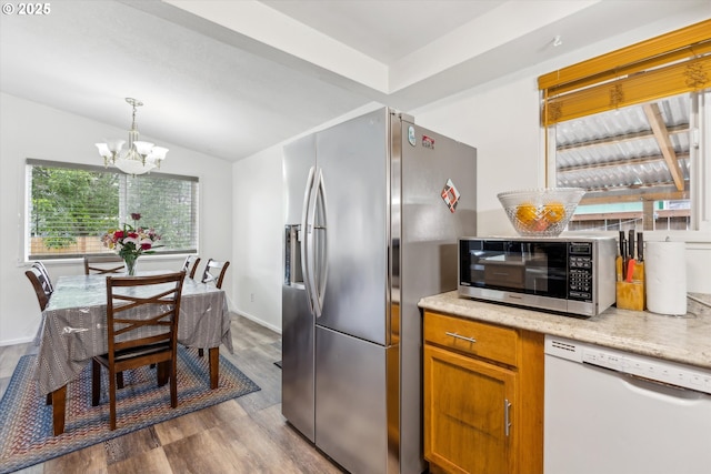 18366 SW Jann Dr, Beaverton, OR 97003 - kitchen featuring white dishwasher, stainless steel refrigerator with ice dispenser, a chandelier, dark wood finished floors, and lofted ceiling