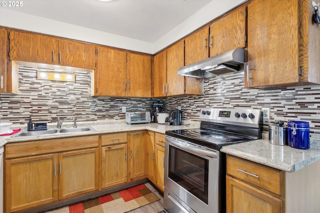 18366 SW Jann Dr, Beaverton, OR 97003 - kitchen featuring electric range, under cabinet range hood, a sink, light countertops, and backsplash