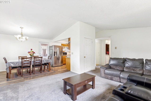 18366 SW Jann Dr, Beaverton, OR 97003 - living room with a chandelier, lofted ceiling, light colored carpet, and baseboards