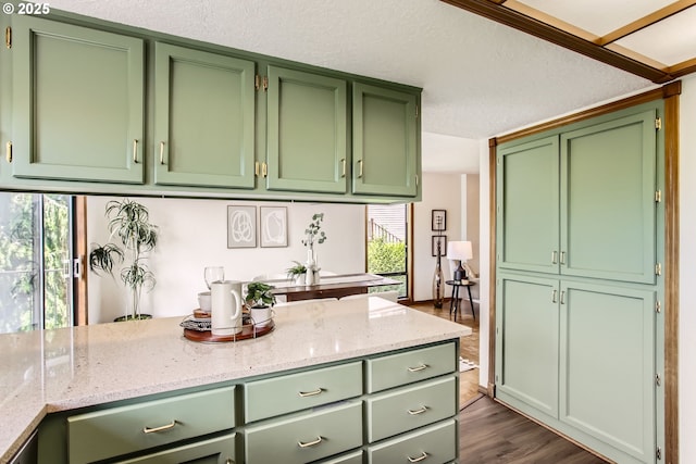 9080 NW Sherry Ct, Portland, OR 97229 - kitchen with green cabinets, dark wood-style flooring, and light stone counters