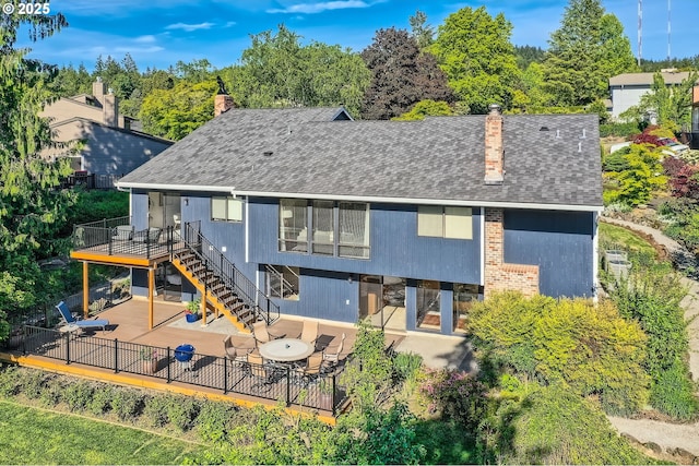 9080 NW Sherry Ct, Portland, OR 97229 - back of property featuring a chimney, a patio, stairs, a deck, and a shingled roof