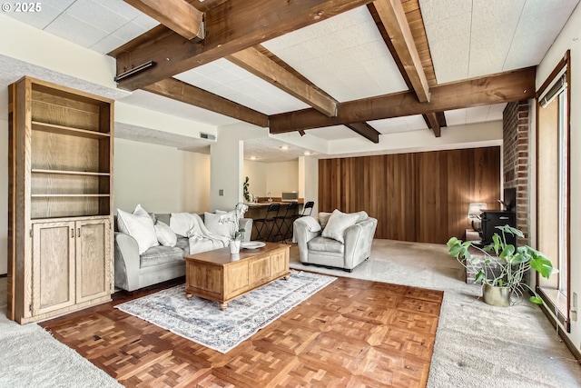 9080 NW Sherry Ct, Portland, OR 97229 - living room featuring beam ceiling, wood walls, and a wood stove