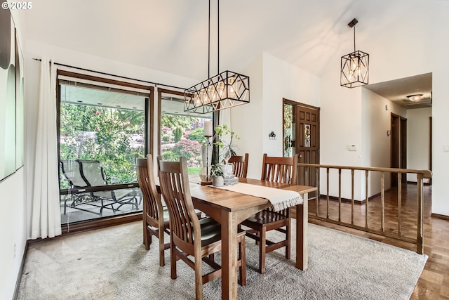 9080 NW Sherry Ct, Portland, OR 97229 - dining space featuring a chandelier, high vaulted ceiling, and baseboards