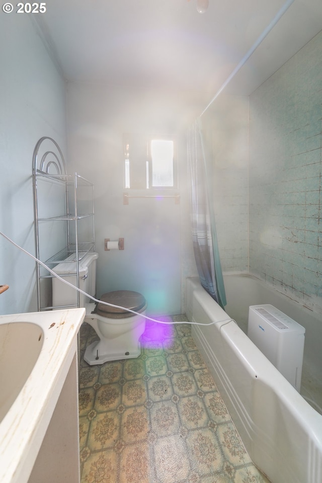full bath with vanity, shower / tub combo, and toilet