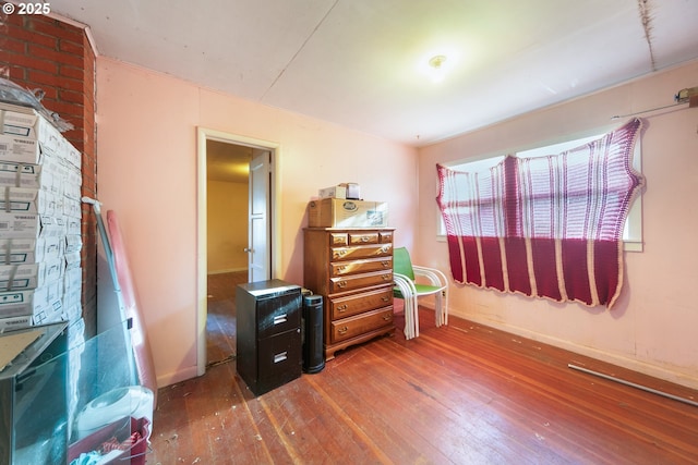 bedroom featuring baseboards and hardwood / wood-style flooring
