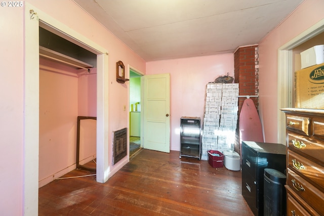 interior space featuring heating unit and hardwood / wood-style floors