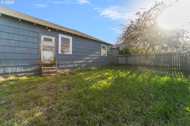 view of yard featuring fence and entry steps