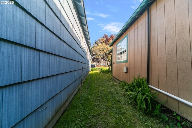 view of side of property with a yard