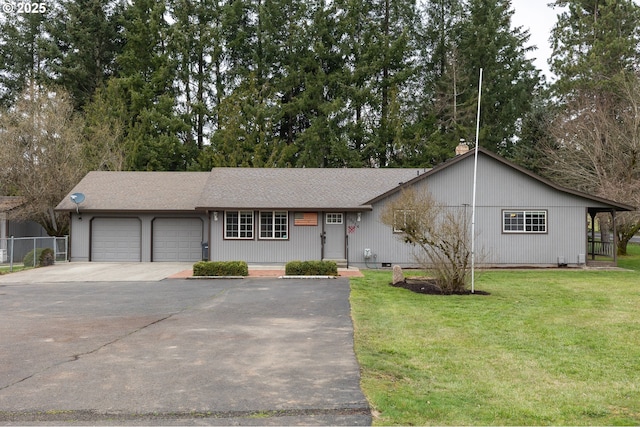 single story home featuring driveway, an attached garage, a front lawn, and fence